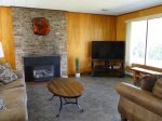 Living room has large screen TV and a gas fireplace 
